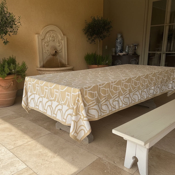 Eclectic sand and white abstract pattern cotton tablecloth on a large outdoor dining table