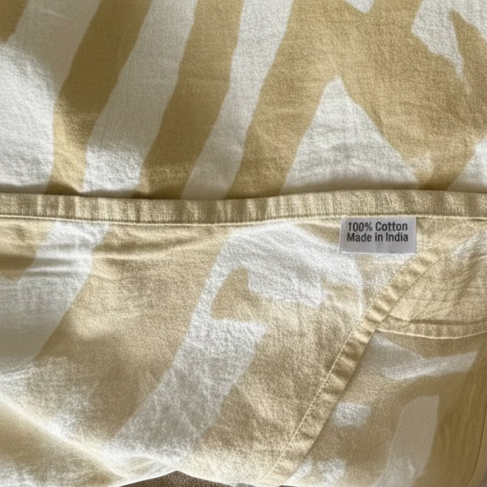 Eclectic sand and white abstract pattern 100% cotton tablecloth with hemmed edge and fabric origin label