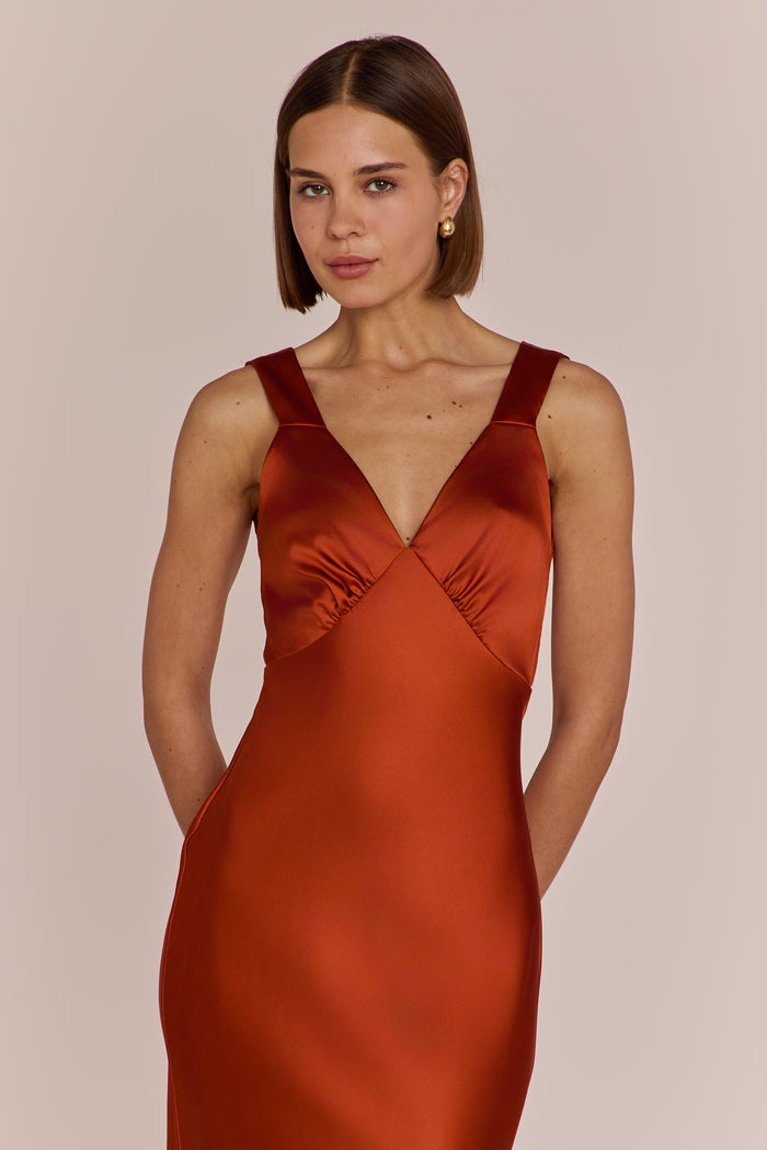 Close up of burnt orange bridesmaid gown with v neck