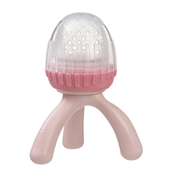 Eclectic B.Box blush silicone fresh food feeder with a tripod base and protective cap for safe baby weaning.