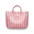 Eclectic blush and neutral striped PVC carry tote bag with fixed shoulder straps and magnetic closure.