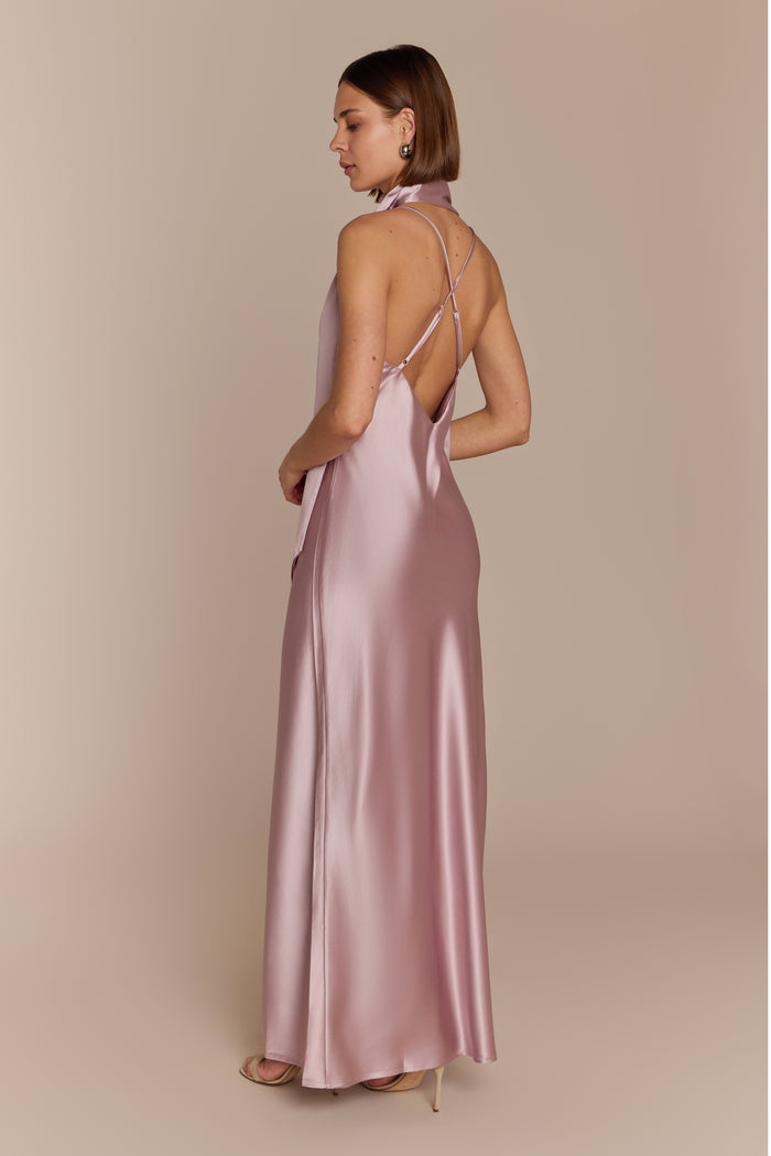 Woman wearing a pink satin bridesmaid gown with a low back