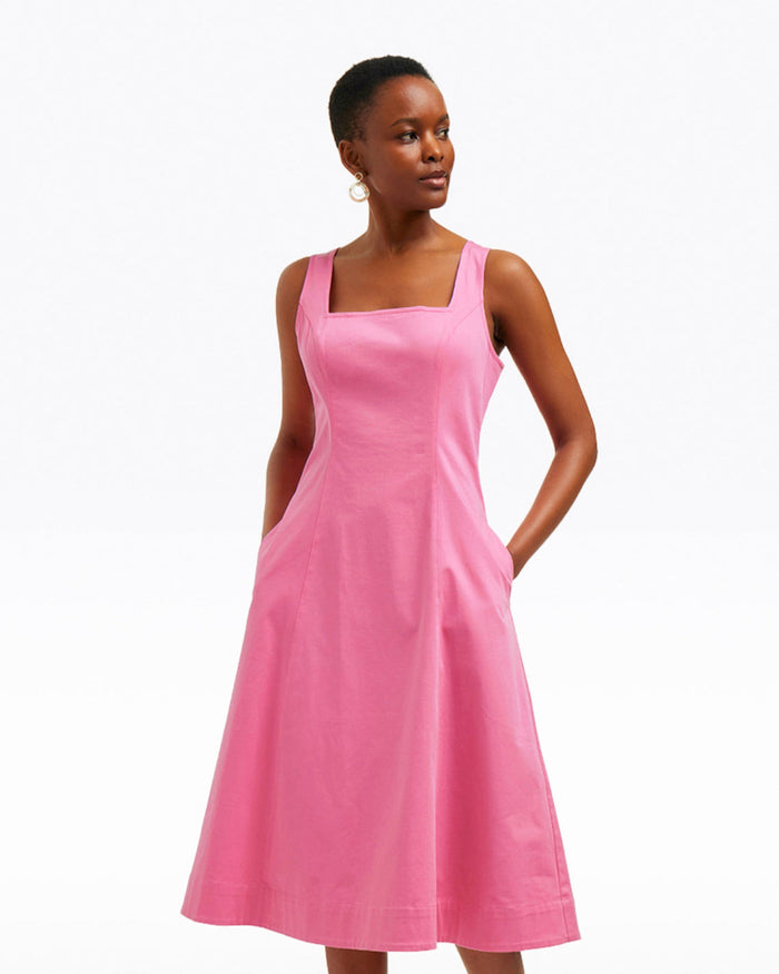 A person wears the Draper James Genevieve Square Neck Sleeveless Midi Dress, featuring a structured cotton design and pockets, standing against a plain white background.
