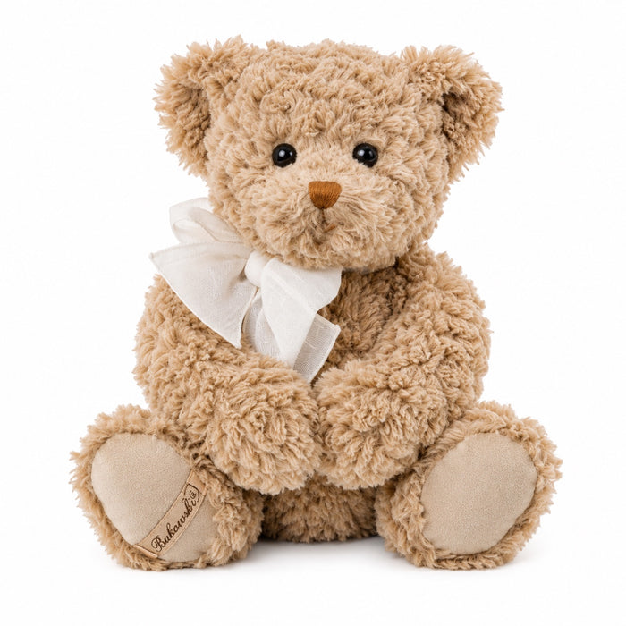 Eclectic Bukowski Bears Harry teddy bear in warm caramel shaggy plush with an elegant ivory bow and embroidered paw.
