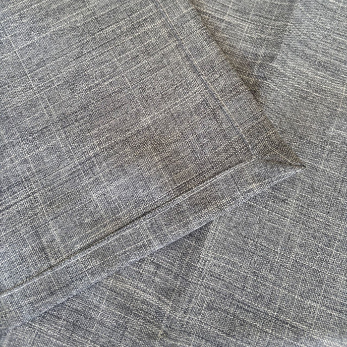 Eclectic ash grey linen-look polyester table runner with a detailed view of the woven fabric texture and stitched hem.