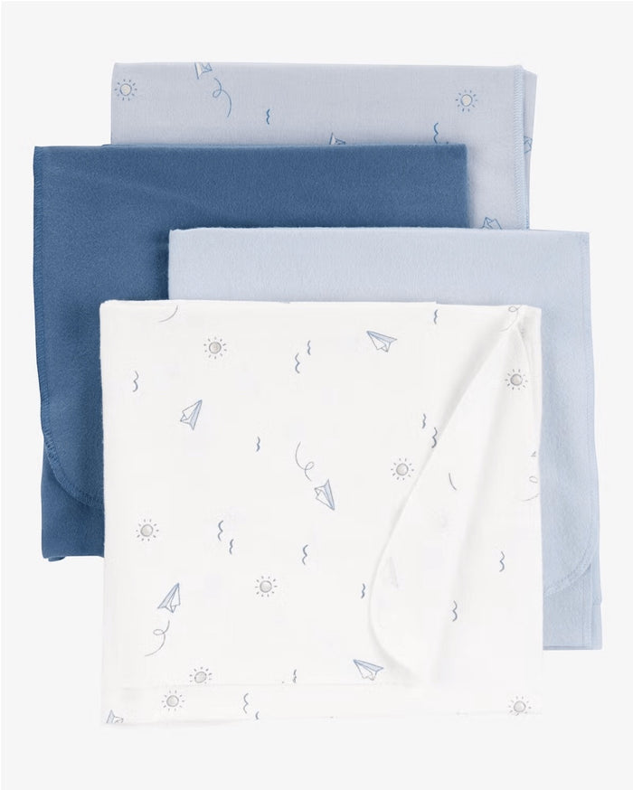 Eclectic Carter’s set of four soft cotton muslin baby swaddles in shades of blue and white with playful sky patterns.