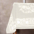 Eclectic natural beige tablecloth with an intricate floral border in a linen-look fabric for an elegant dining setting.