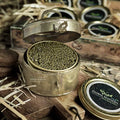 Royal Crown Ossetra Caviar served with blinis, crème fraîche, and lemon garnish