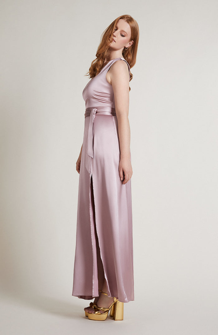 Women wearing a pink satin prom dress with a sash