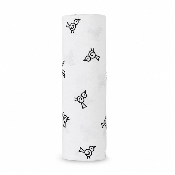 Eclectic Aden + Anais Twitter Bird muslin swaddle blanket in white with a black bird pattern, rolled up.