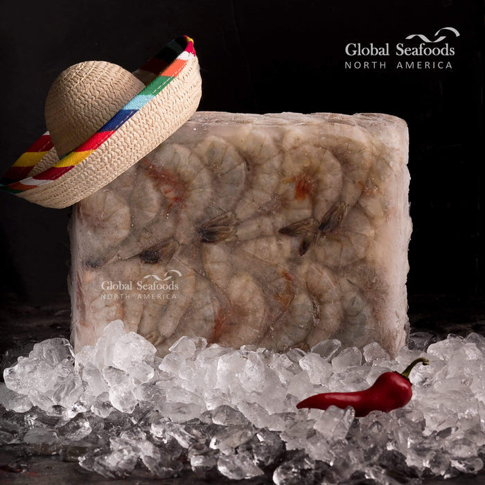 Frozen block of jumbo wild Blue Mexican shrimp tails displayed on ice, accompanied by a traditional Mexican hat for an authentic and culturally themed seafood presentation